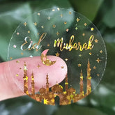Decoratieve Eid Mubarak sticker goud transparant met sterren en moskee silhouetten